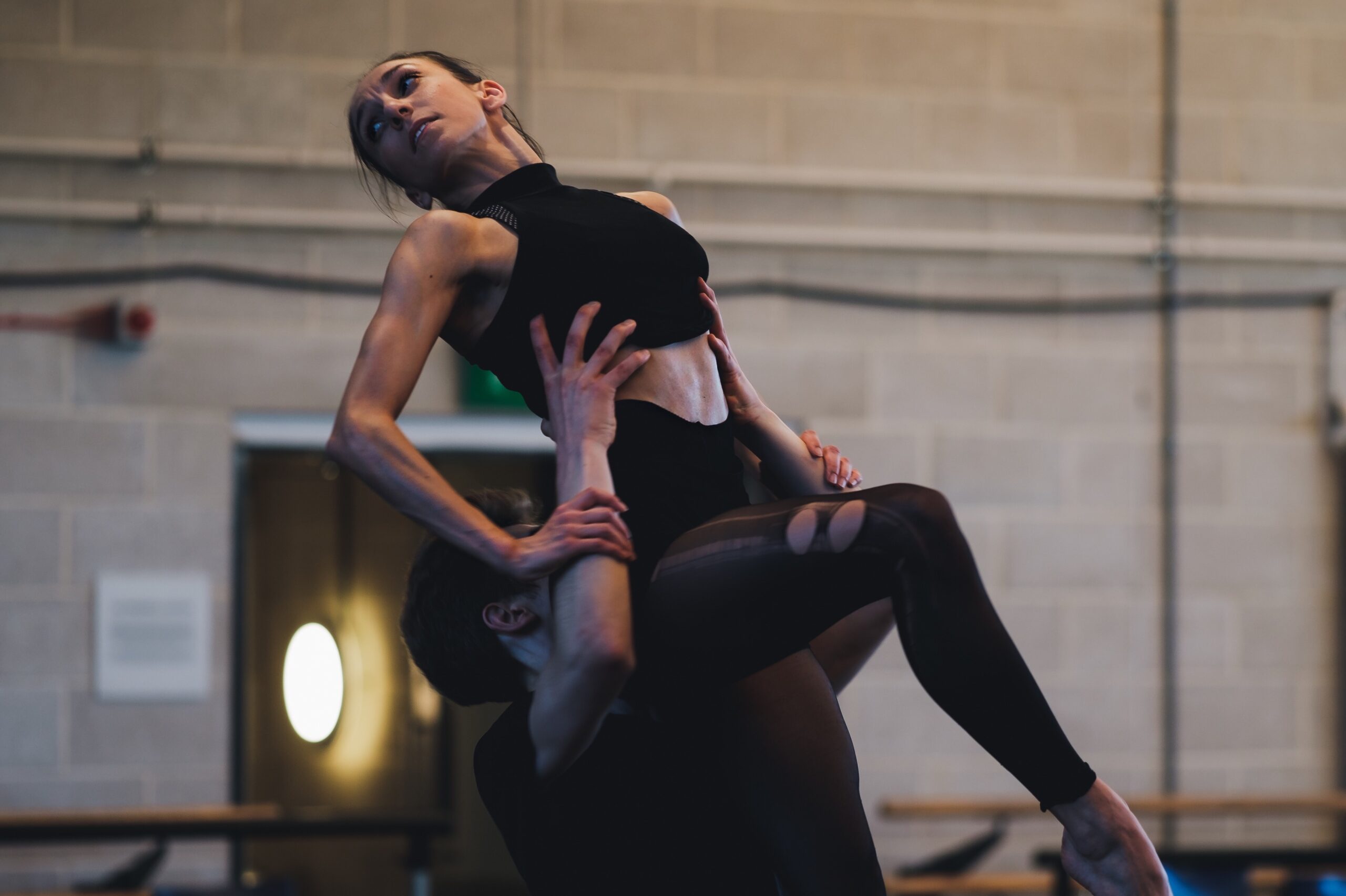 Kate Lyons as Victoria Page being lifted by Jackson Fisch in the Fonteyn Studio at Sadler's Wells Theatre, rehearsing Matthew Bourne's The Red Shoes Boy Girl duet