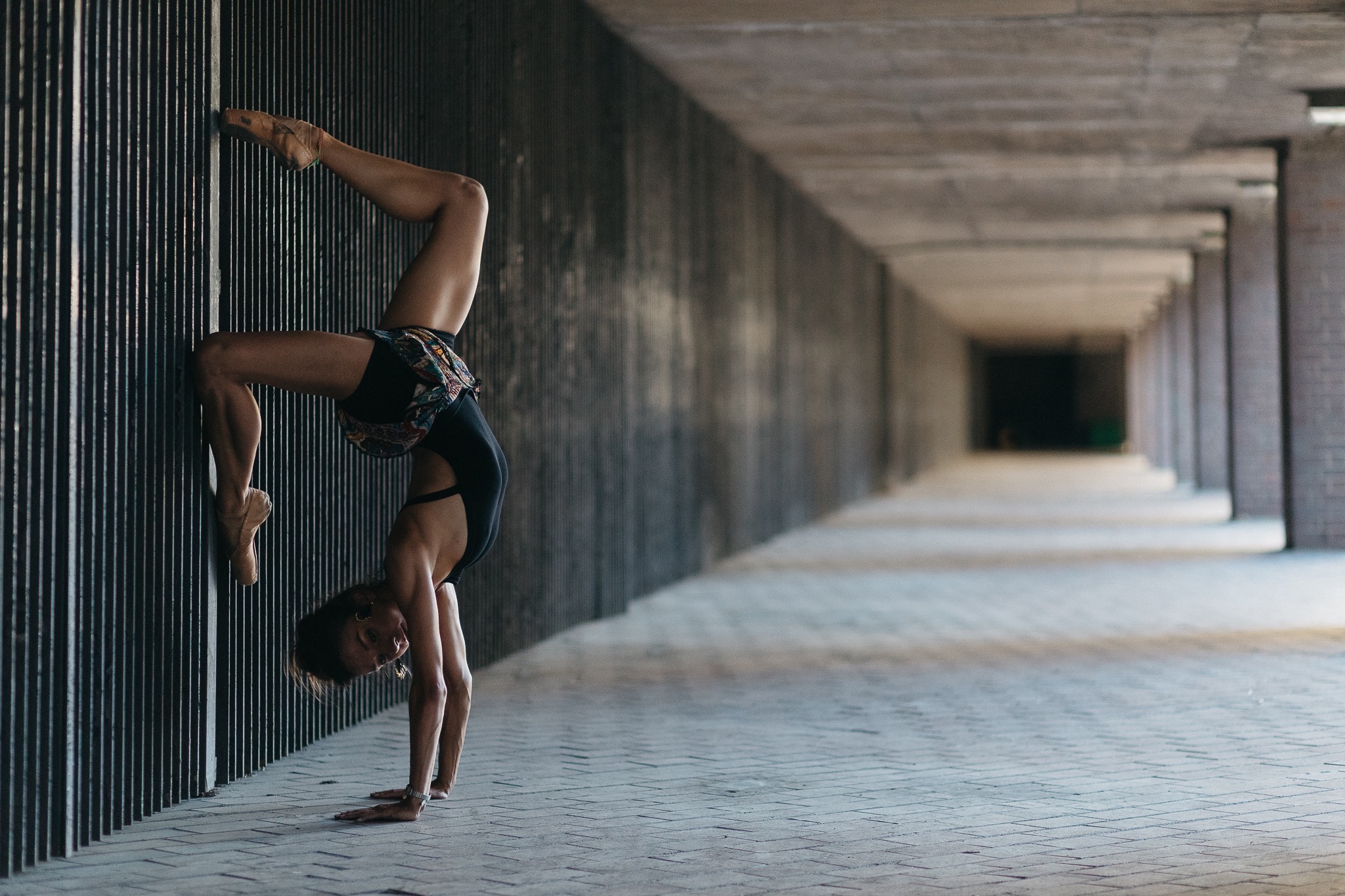 Kate Lyons outside at the Barbican doing a handstand for Pedestrians on Pointe