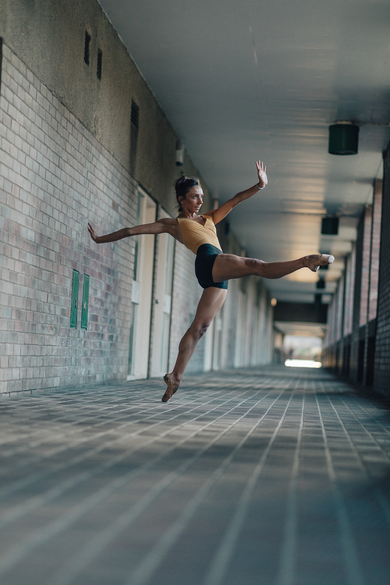 Kate Lyons in a battement devant for Pedestrians on Pointe by Alex Fine outside at the Barbican