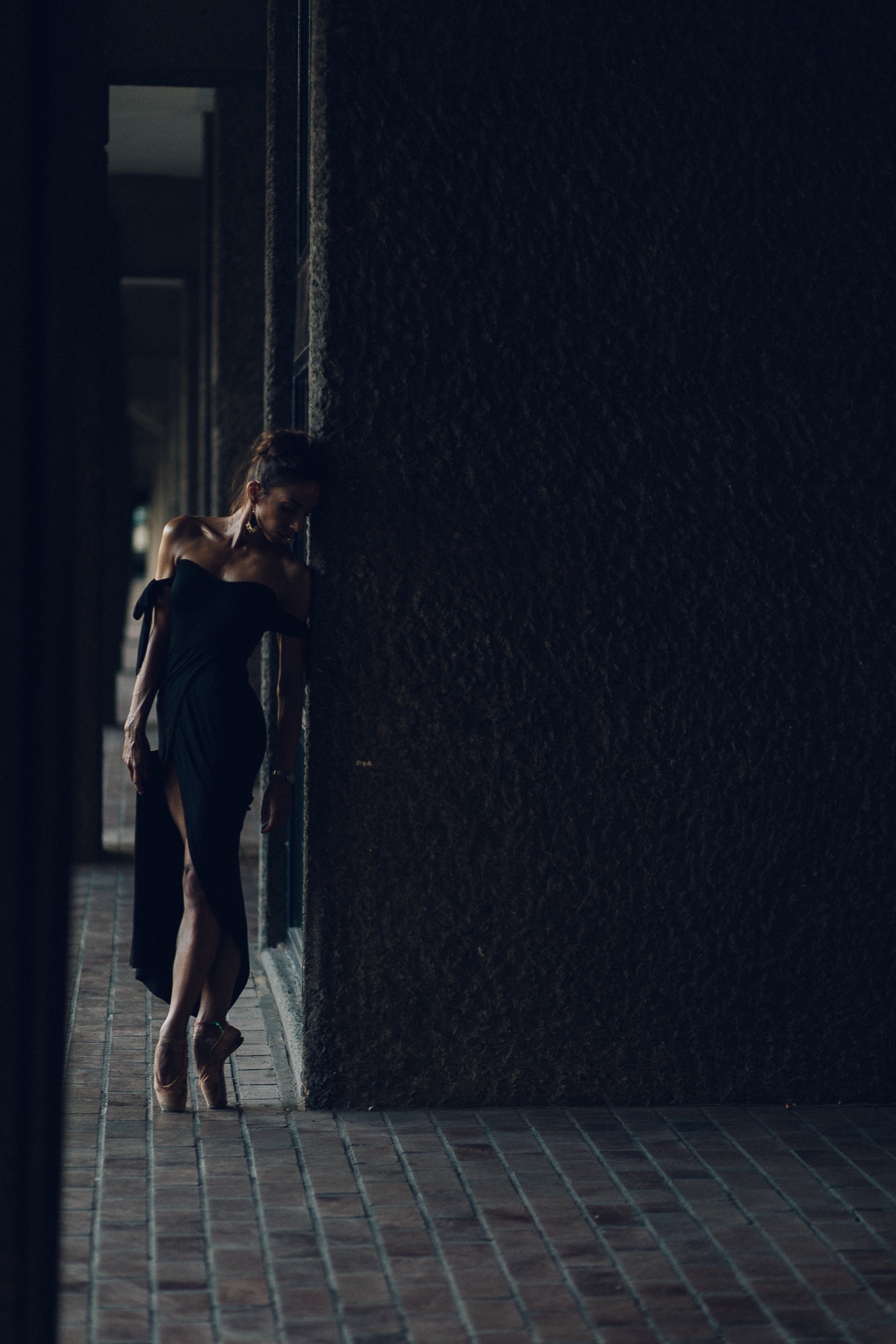 Kate Lyons standing in 5th position for Pedestrians on Pointe Alex Fine, outside at the Barbican 