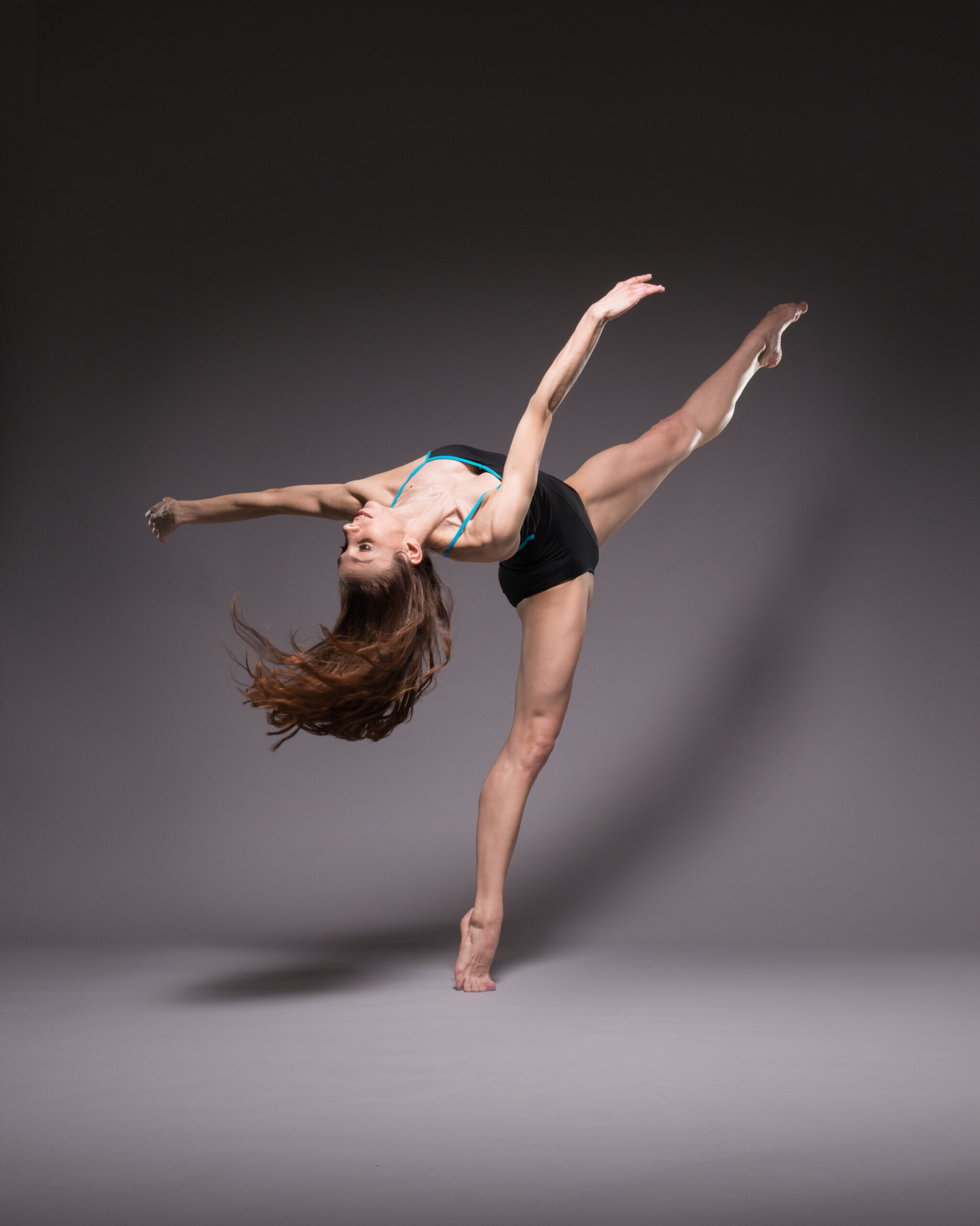 Kate Lyons in a lay out on demi pointe, dance studio Photography by ASH