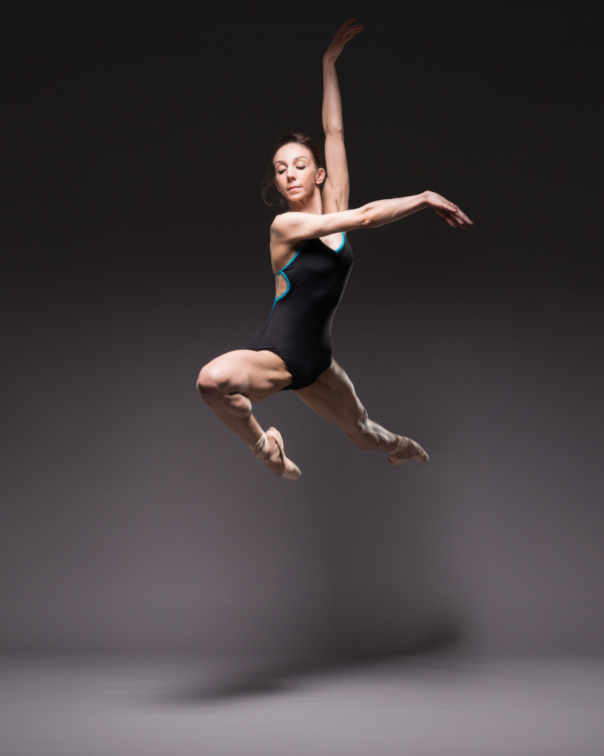 Kate Lyons jumping a Pas de Chat, dance studio Photography by ASH